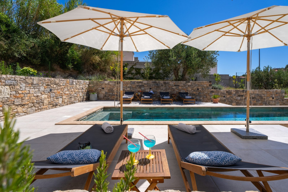 There is a sun deck area with 6 deck chairs, an outdoor shower, a covered outdoor dining area