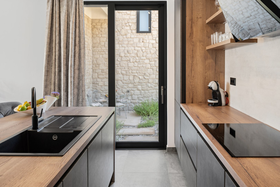 Fully equipped kitchen with all needed amenities like wine cooler, Dolce Gusto and filter coffee maker, a microwave oven, kettle, and others