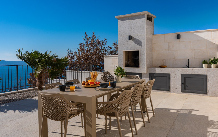 The outdoor barbecue station is ideal for wood or charcoal grilling during your luxurious retreat.