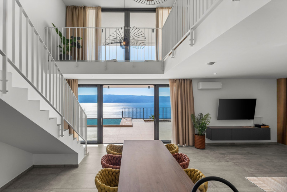 Modern dining table located within a spacious 60-square-meter living area.