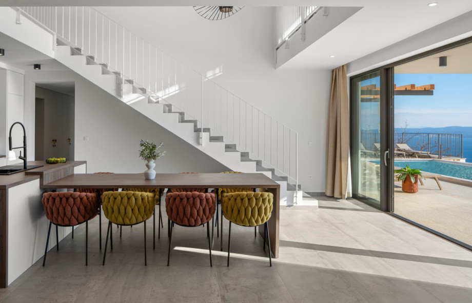 The 60sqm living area includes a stylish dining table that opens directly to the pool area.