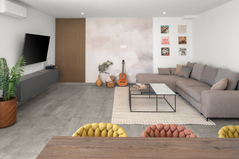 The spacious ground-floor living area is fully air-conditioned and features a TV and a PlayStation 5.