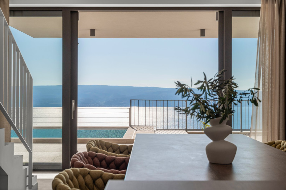 Dining area with sliding doors that open directly to the pool area.