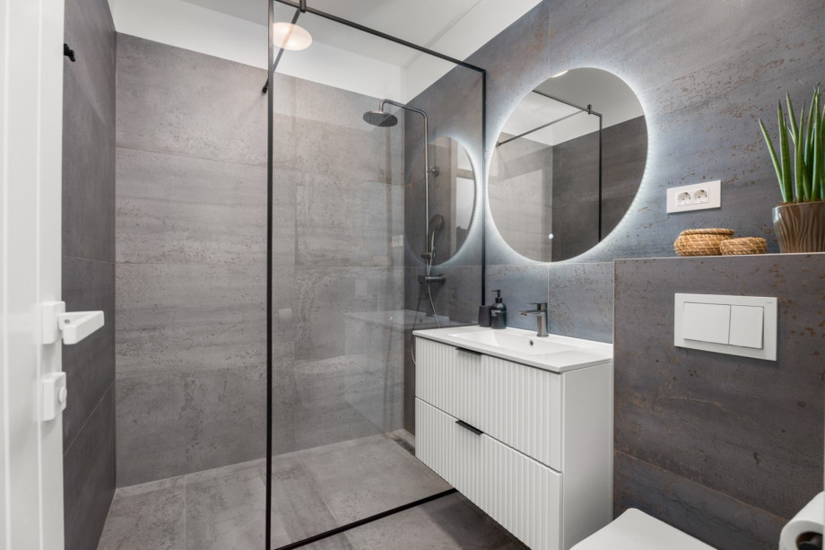 Each modern bedroom includes a private en-suite bathroom equipped with a walk-in shower.