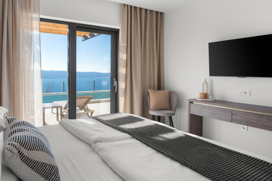 Modern bedroom featuring a smart TV and a king-size bed.