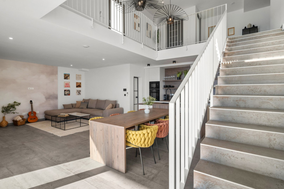 Spacious 60 sqm open-plan living area with a fully equipped kitchen and island.