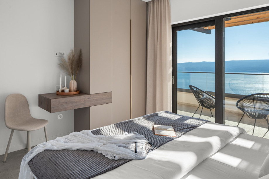 Beautifully furnished bedroom with a king-size bed and a wardrobe.