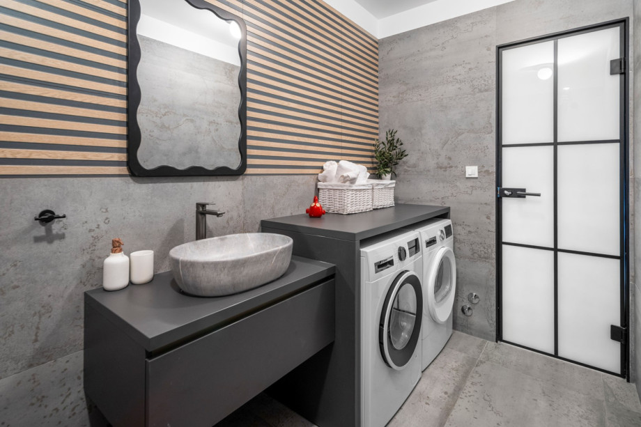 For added convenience, the villa features a laundry corner with a washing machine and dryer.