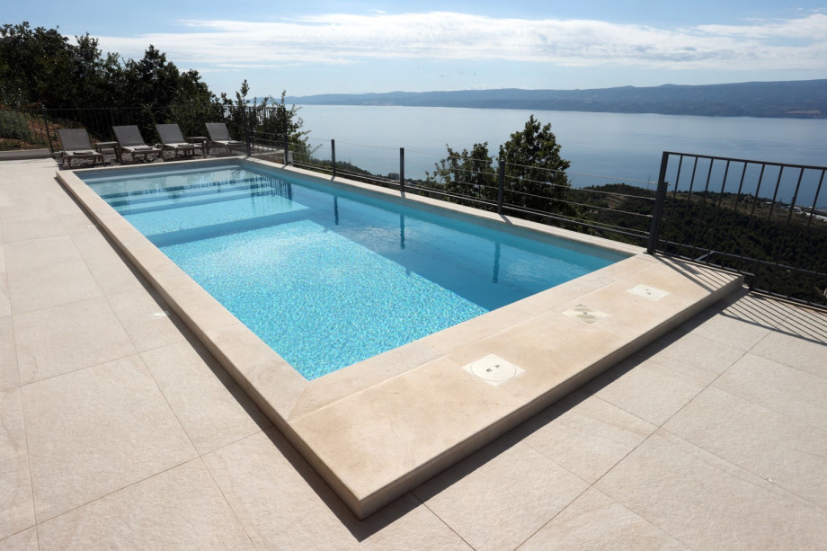 The pool's shallow section offers a gentle entry for a refreshing dip.