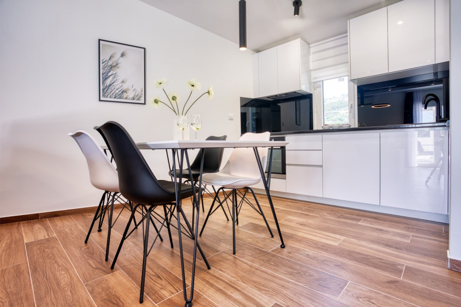 a fully equipped kitchen, dining area