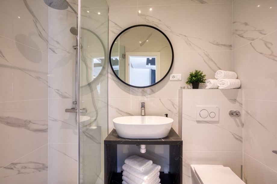 a Family bathroom with a shower
