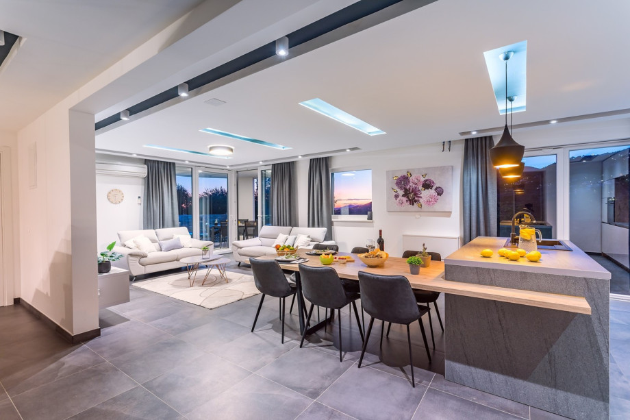 villa offers a spacious living and dining area with exit to pool