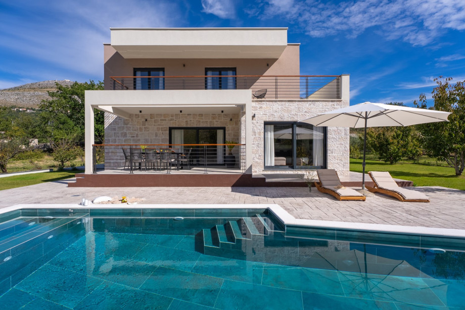 A stylish 4-bedroom retreat with a private pool and spacious balconies for a perfect holiday.