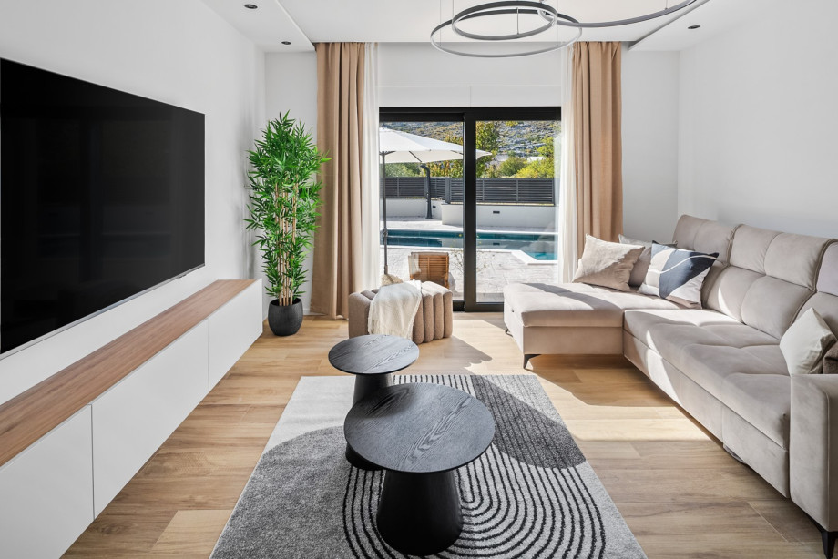 Relax on the comfortable sectional sofa for a movie night or gaze out at the sparkling swimming pool.