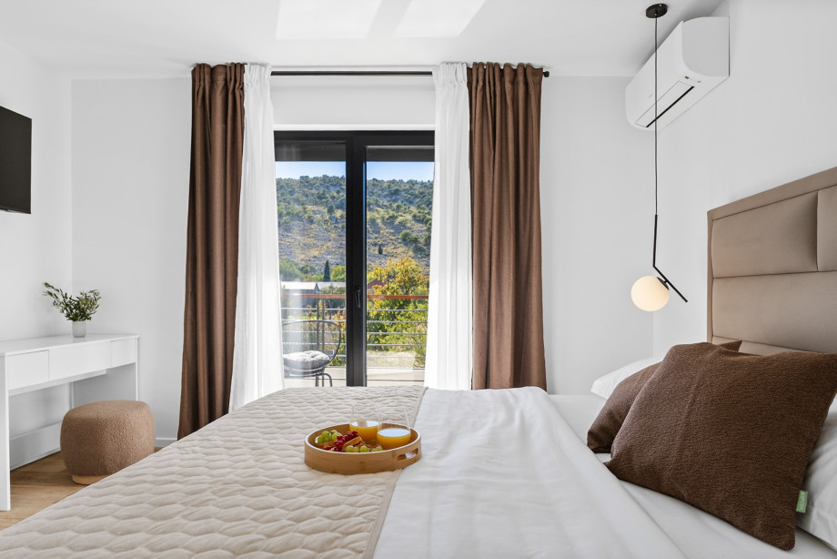 Enjoy mornings in a comfortable king-size bed while taking in the views of the lush surroundings.