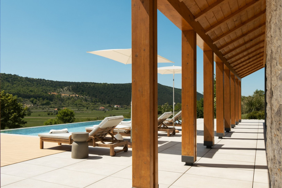 A covered terrace with a summer kitchen provides the perfect setting for al fresco dining and entertaining.