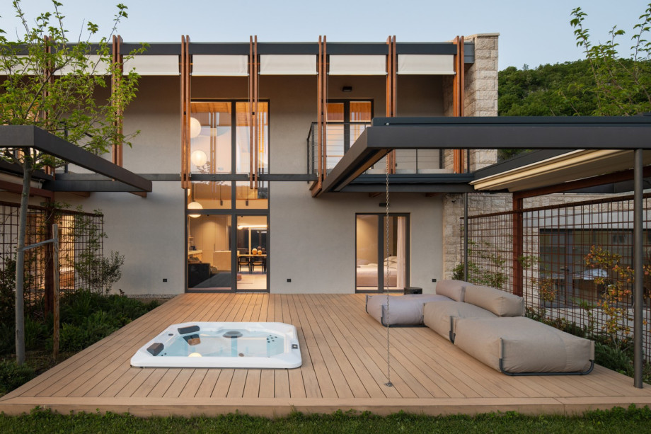 The southern terrace offers a relaxing lounge area and a private hot tub.