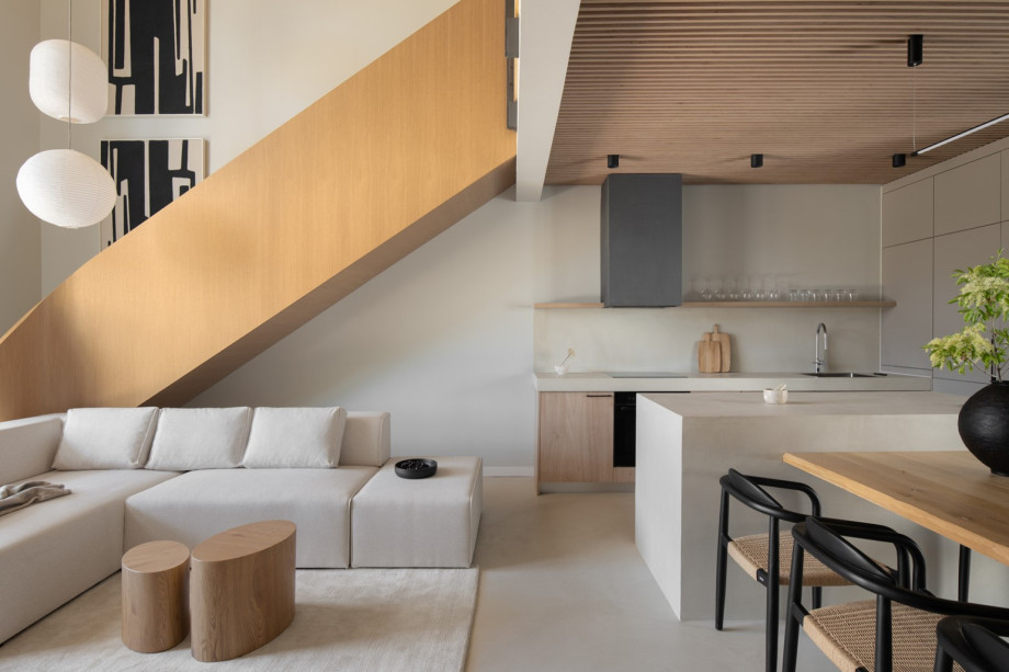 The ground floor living room connects to a fully equipped kitchen with top-of-the-line appliances.