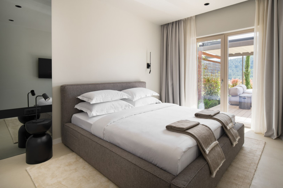 One of the stylish bedrooms features an en-suite bathroom, air conditioning and a king-size bed.