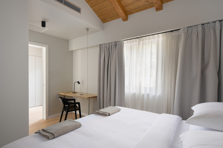 A bright bedroom with a built-in desk area.