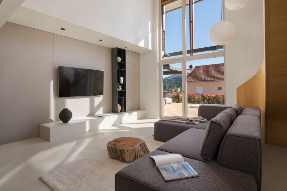 Sun-drenched living room with high ceilings, a large TV, and views of the Dalmatian landscape.