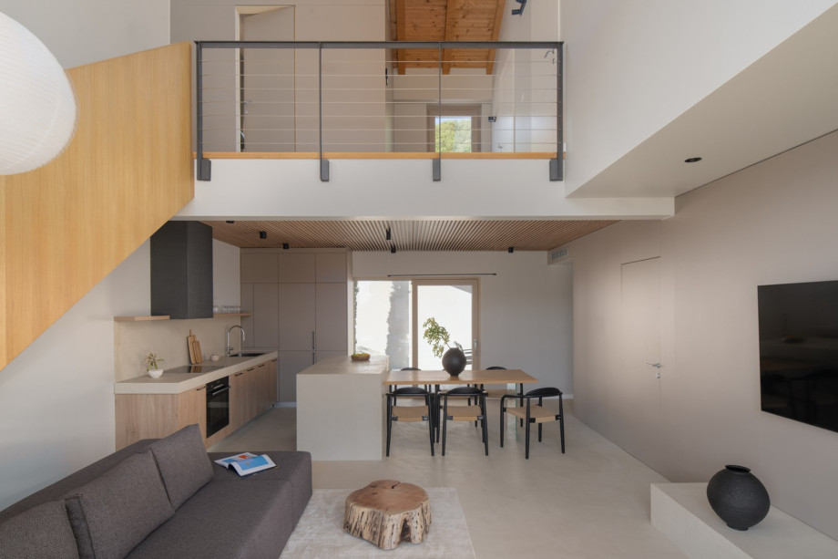 Open-plan living space and fully equipped kitchen featuring a sleek island and dining area.