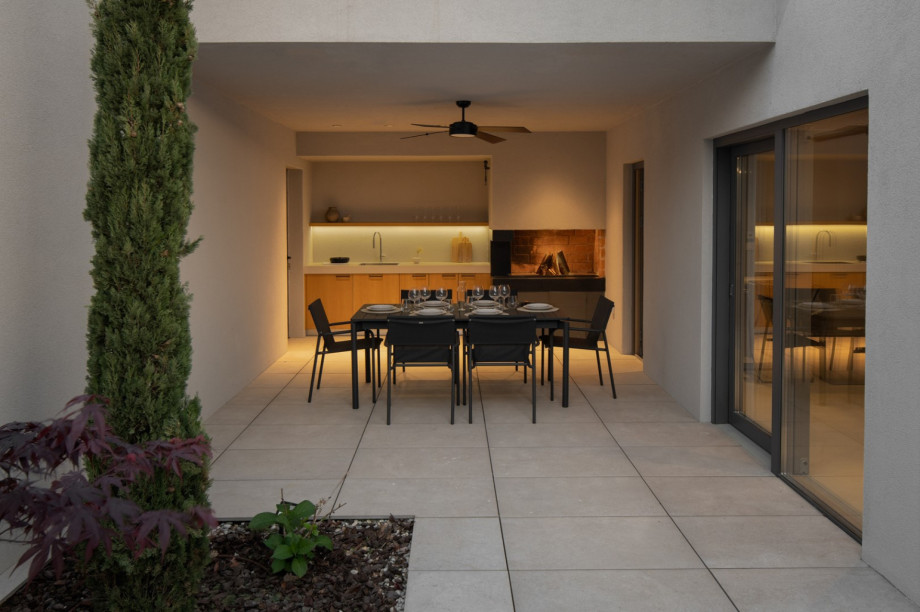 Covered summer kitchen and elegant dining area, perfect for al fresco gatherings.