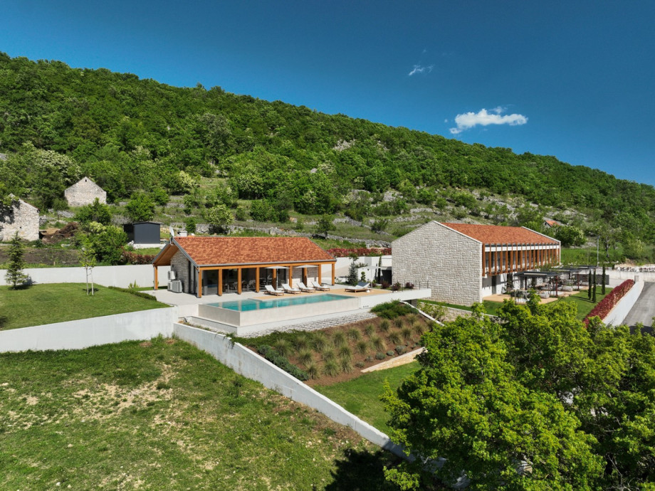 Enjoy seamless indoor-outdoor living with a heated pool and covered terraces.