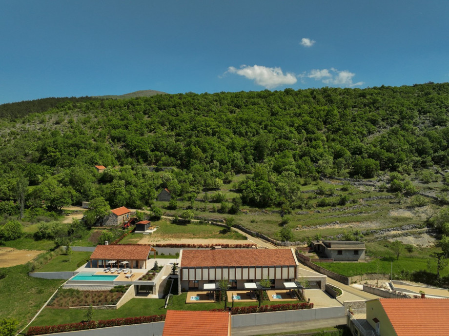 The property features a private paddle court and 3 distinct living units designed for privacy and comfort.