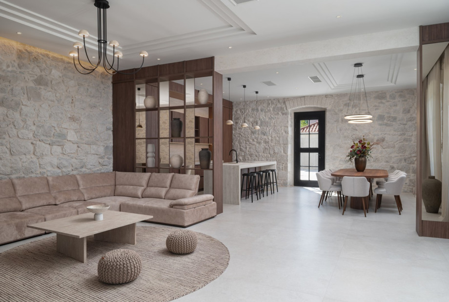 The gourmet kitchen features a kitchen island, stools, and a dining table with direct access to the pool area.