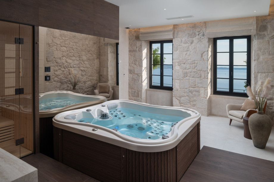The spa zone features a hot tub, Finnish sauna, and a relaxing corner with sea views for rejuvenation.
