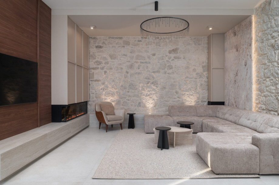 An inviting living room offers a stylish sofa and high ceilings for a spacious, airy ambience.