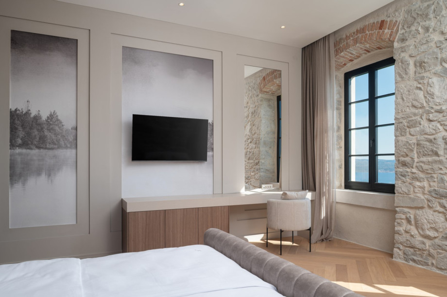 Stylish bedrooms include flat-screen TVs and large windows overlooking the Adriatic Sea.