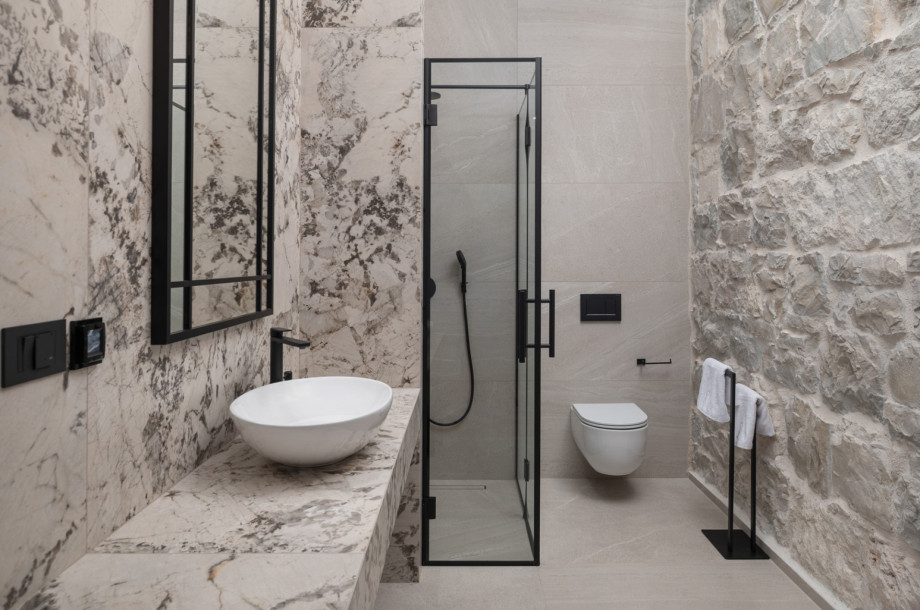 Modern en-suite bathrooms feature high-quality materials and a clean, sophisticated design.