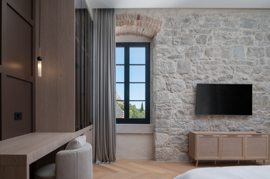 This room is renovated in a classic Mediterranean style, utilising natural stone and wood.
