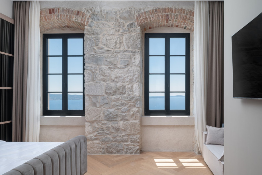 Large windows in the bedroom provide breathtaking panoramic views of the Adriatic Sea and islands.