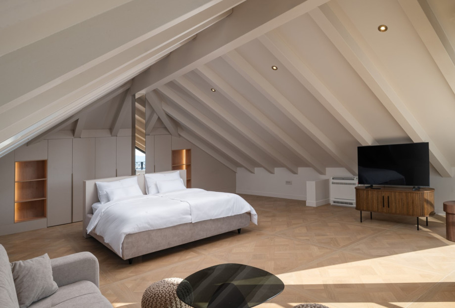 This attic retreat features a king-size bed and custom furnishings with sea views.