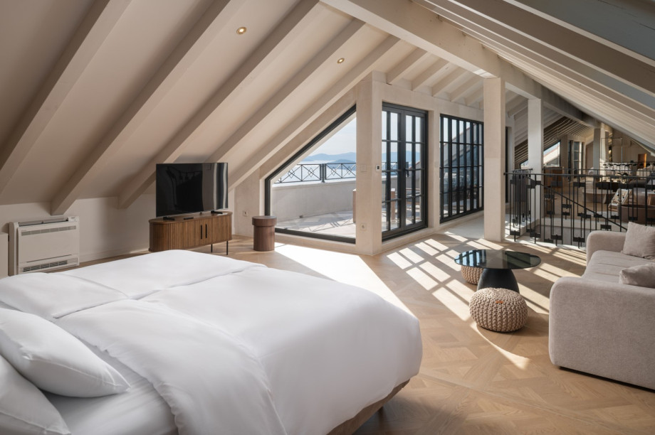 The open-plan attic offers a stylish living area and access to a fenced balcony.