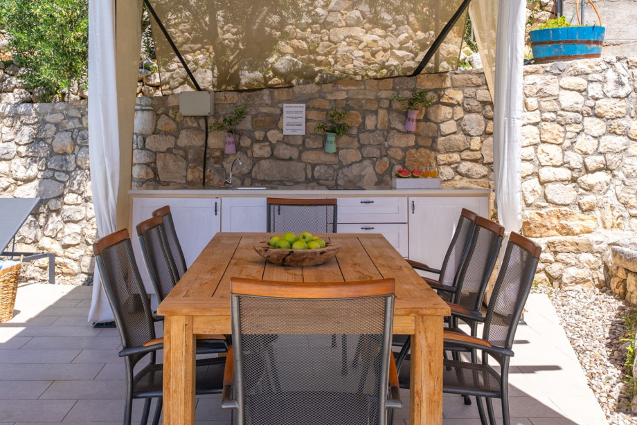 Outdoor kitchen and dining table at the pool area.