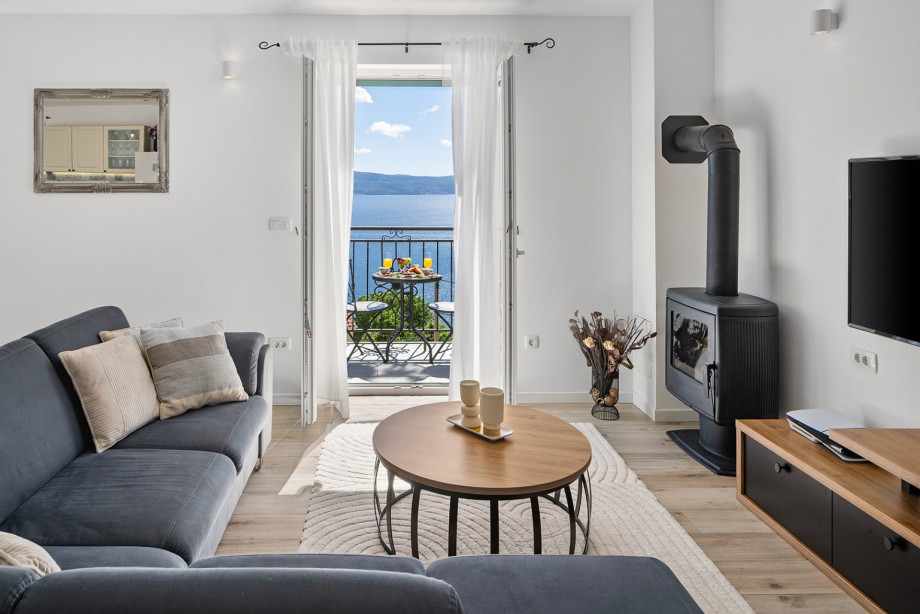 Living room, with an AC, PS 5 and a fireplace