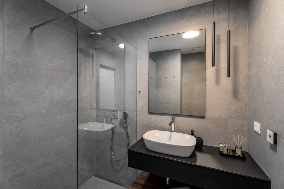 En-suite bathroom with a shower and sea views.