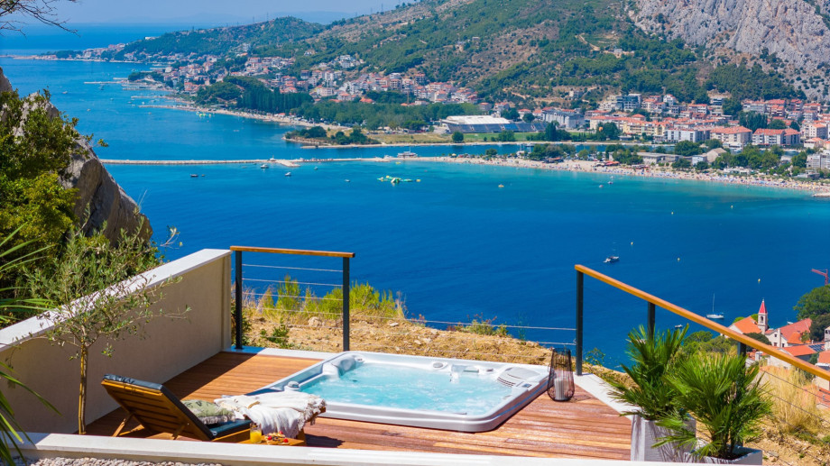 There is a hot tub (also known as a Whirlpool) with breathtaking views of the sea located on a lower deck