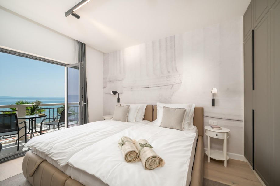 Bedroom NO2 (15,2sqm) with super king size bed 200x200 (can be separated into two singles), A/C, a TV, en-suite bathroom with a shower,  a balcony, and sea-views