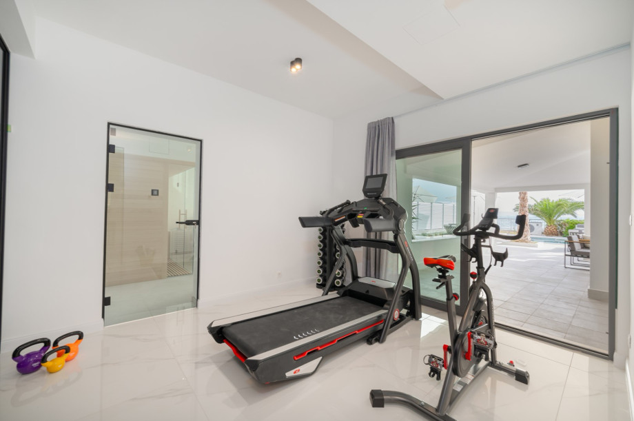 There is a Gym area (22 sqm) with a treadmill, exercise bike, a bench, and some weights and pilates equipment