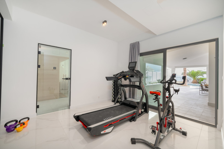 There is a Gym area (22 sqm) with a treadmill, exercise bike, a bench, and some weights and pilates equipment