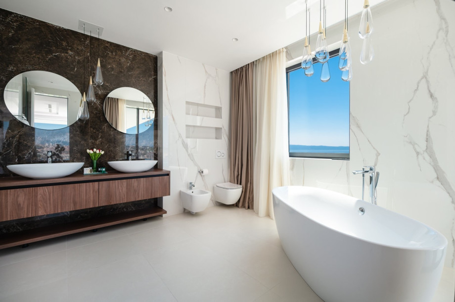 An en-suite bathroom with a bathtub, a shower, a sink, and a toilet