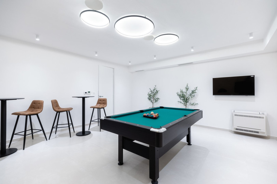 There is also a laundry with a washing machine, a dryer, and ironing amenities next door