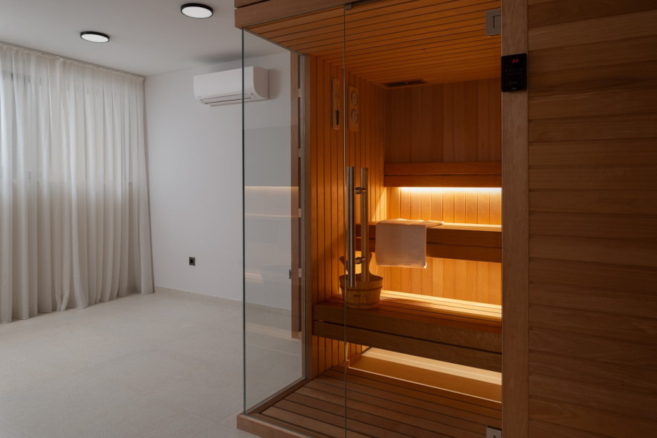There’s also a dedicated spa room featuring a Finnish sauna, exercise bike, a TV, and shower, along with laundry facilities that include a washing machine and dryer.