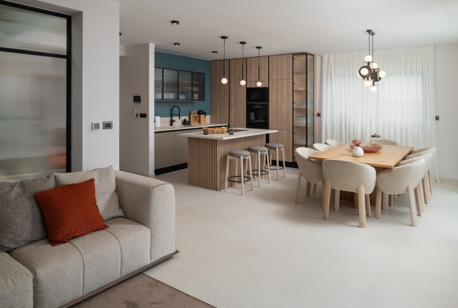 The stylish living area features a flat-screen TV, air conditioning