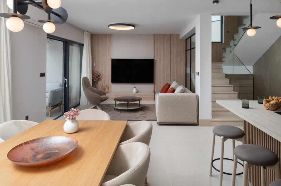 The stylish living area and direct access to the pool and outdoor dining area.